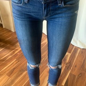 Dark wash PAIGE ripped jeans.